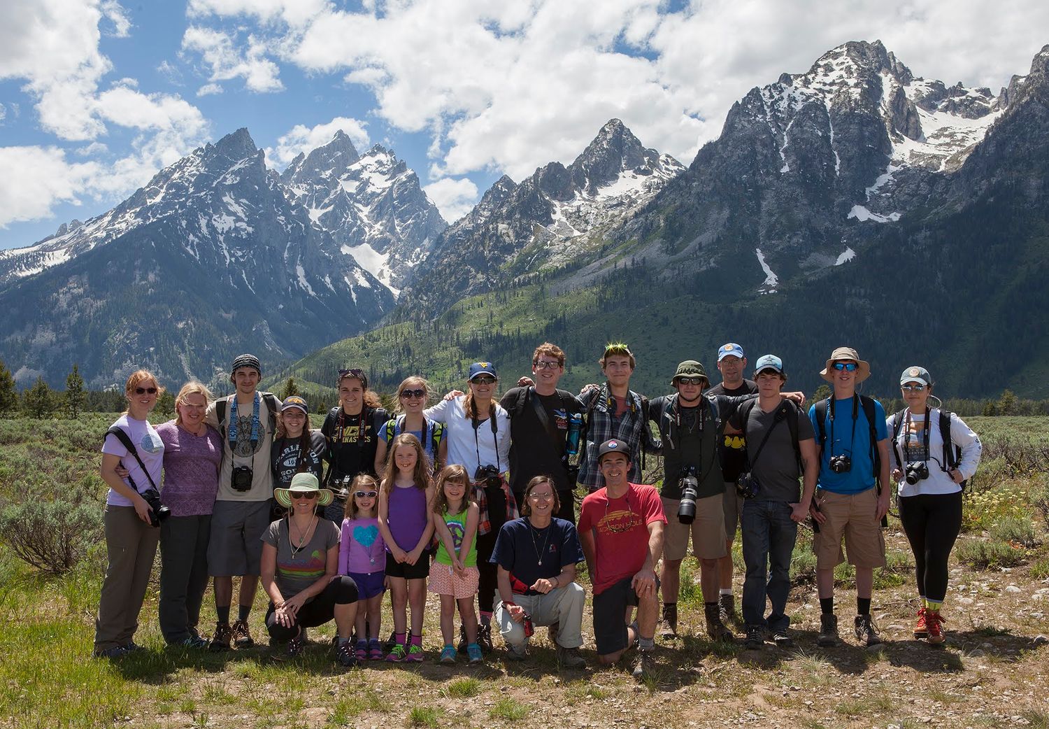 students stand in front of a mountain