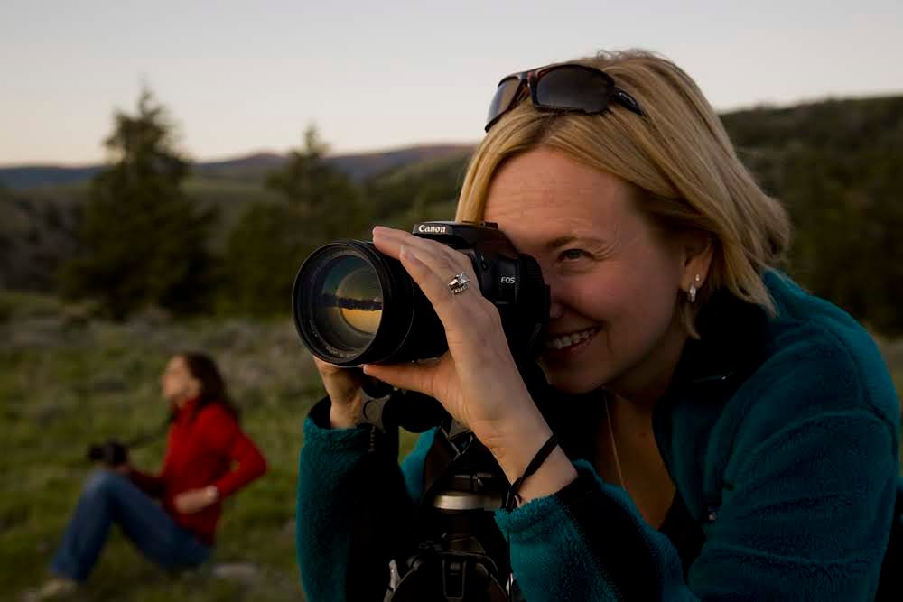woman smiling while taking a photo