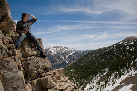 a student sits on a mountain top