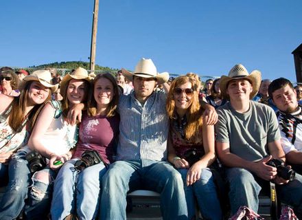 students smile while wearing cowboy hats
